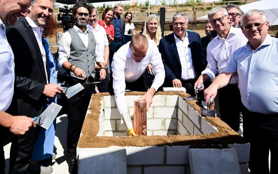 Christian Reichert legt die Zeitkapsel in den Grudnstein.